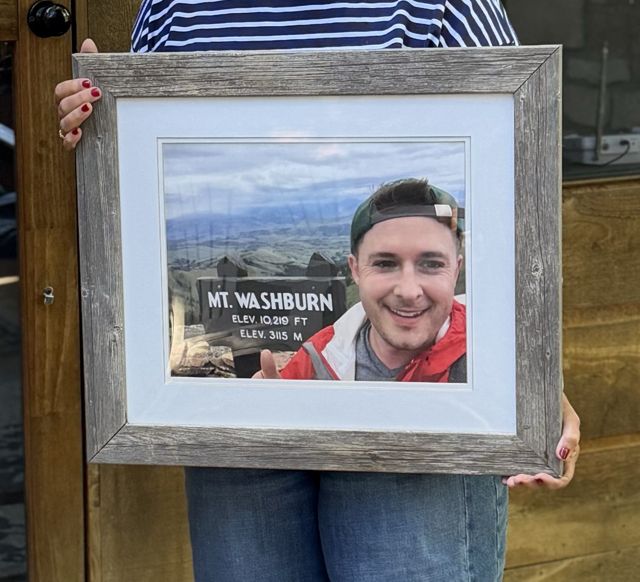 Grieving mom holding photo of the son she lost
