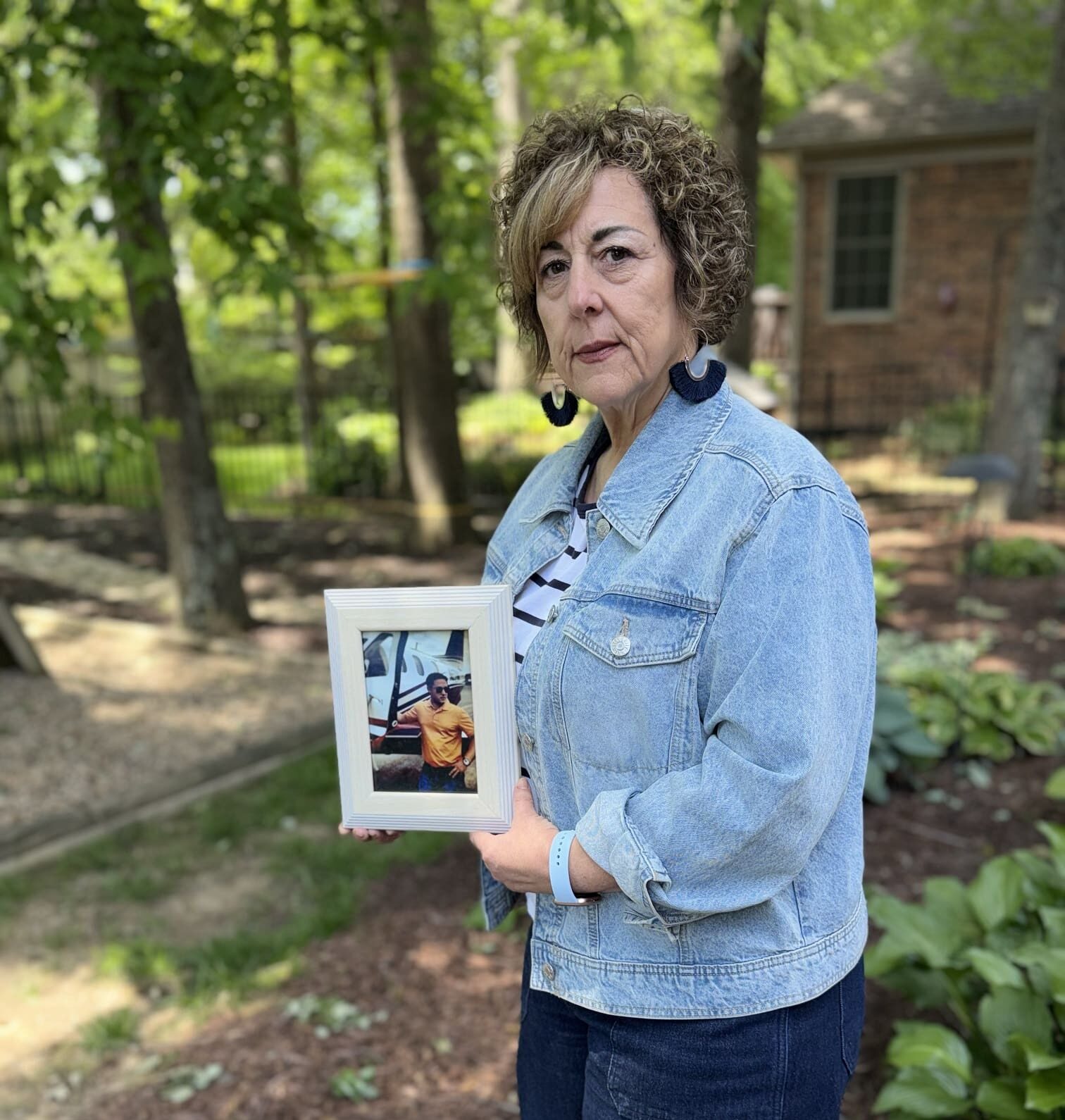 Grieving Mother holding photo of son
